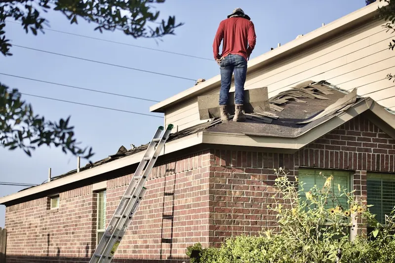 Professional roofer working on a residential roof in Mantua Hills